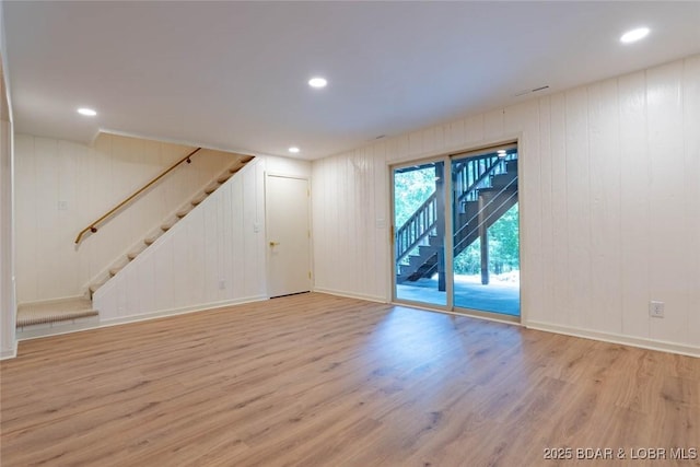 1408 Dogwood Ln, Osage Beach, MO 65065 - unfurnished living room with stairway, light wood-type flooring, recessed lighting, and wooden walls
