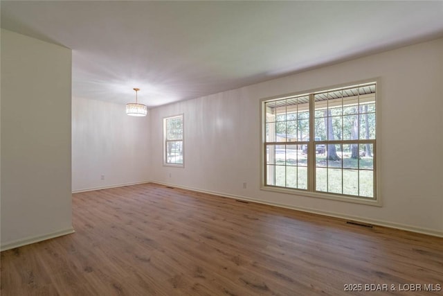 1408 Dogwood Ln, Osage Beach, MO 65065 - empty room with wood finished floors and a chandelier