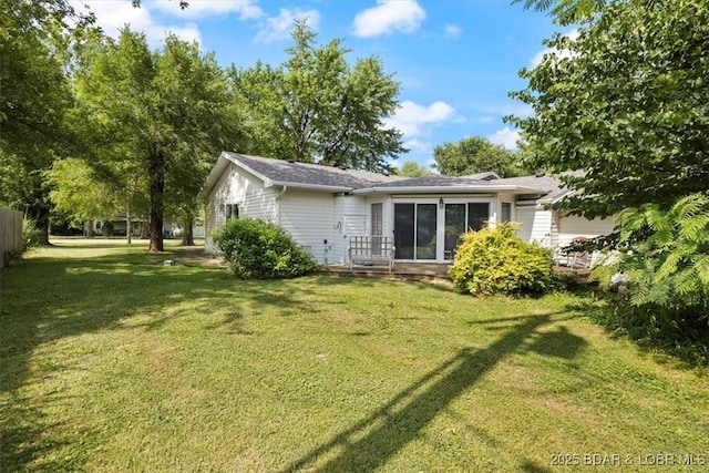 901 Larkin Dr, Eldon, MO 65026 - rear view of property with a lawn and a garage