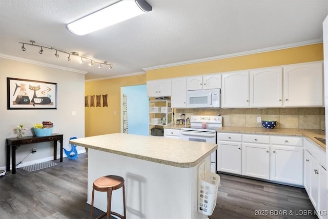 901 Larkin Dr, Eldon, MO 65026 - kitchen featuring white appliances, crown molding, a center island, light countertops, and white cabinetry