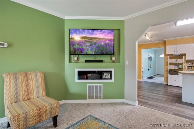 901 Larkin Dr, Eldon, MO 65026 - sitting room featuring crown molding and dark colored carpet