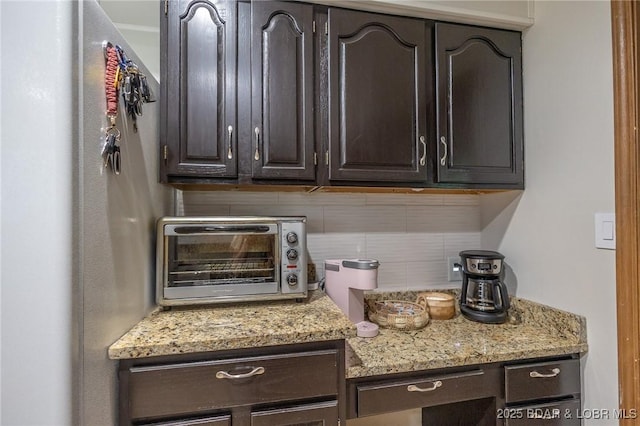 278 Panoramic Dr, Camdenton, MO 65020 - kitchen with decorative backsplash, dark brown cabinetry, and light stone counters