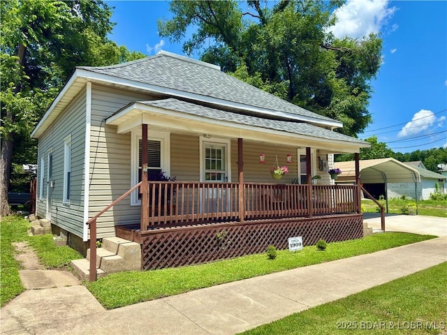 435 Main St, Newburg, MO 65550 - bungalow featuring a shingled roof, covered porch, and a carport