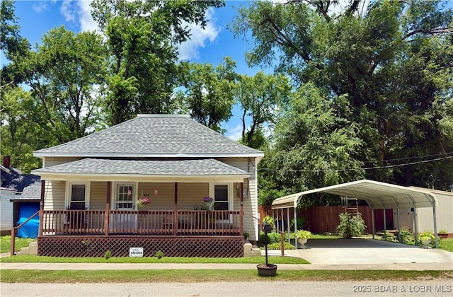 435 Main St, Newburg, MO 65550 - view of front of house featuring roof with shingles, covered porch, a detached carport, and driveway
