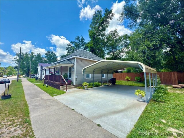 435 Main St, Newburg, MO 65550 - view of front facade featuring concrete driveway, a detached carport, and a porch