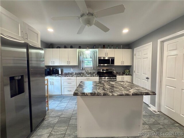 435 Main St, Newburg, MO 65550 - kitchen featuring stainless steel appliances, white cabinetry, recessed lighting, a ceiling fan, and a kitchen island