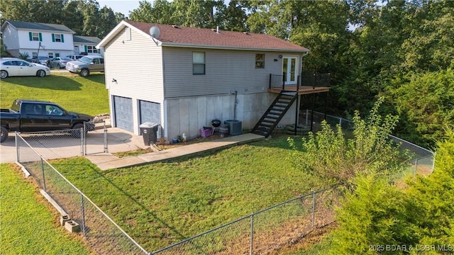 195 Jamie Dr, Camdenton, MO 65020 - rear view of house with stairway, driveway, and a garage