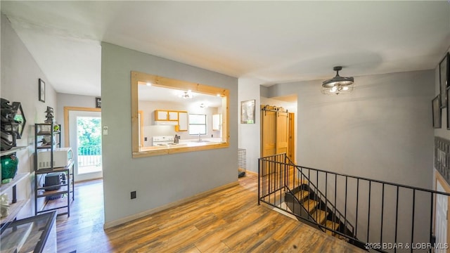 195 Jamie Dr, Camdenton, MO 65020 - hall with an upstairs landing and wood finished floors