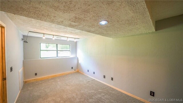 195 Jamie Dr, Camdenton, MO 65020 - spare room with carpet, rail lighting, and a textured ceiling