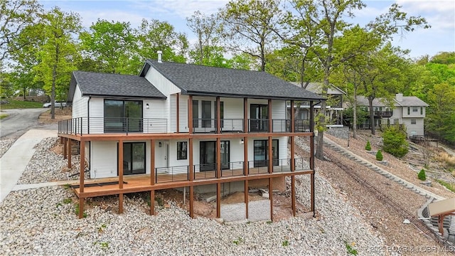 4452 Hamrock Ln, Osage Beach, MO 65065 - rear view of property featuring a balcony and a shingled roof