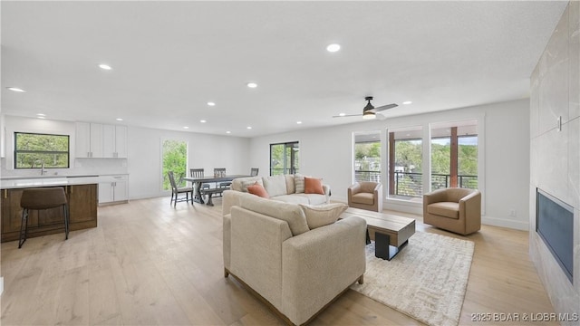 4452 Hamrock Ln, Osage Beach, MO 65065 - living area with recessed lighting, light wood-type flooring, a fireplace, and ceiling fan