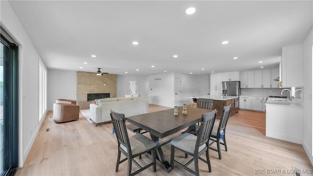 4452 Hamrock Ln, Osage Beach, MO 65065 - dining space featuring recessed lighting, light wood finished floors, and a tile fireplace