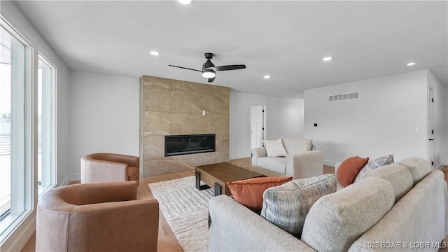 4452 Hamrock Ln, Osage Beach, MO 65065 - living room with recessed lighting, plenty of natural light, ceiling fan, a fireplace, and wood finished floors