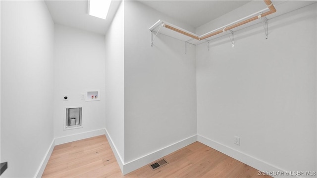 4452 Hamrock Ln, Osage Beach, MO 65065 - laundry area with light wood-style flooring, hookup for an electric dryer, and washer hookup