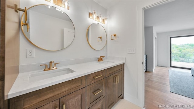 4452 Hamrock Ln, Osage Beach, MO 65065 - bathroom with double vanity and wood finished floors