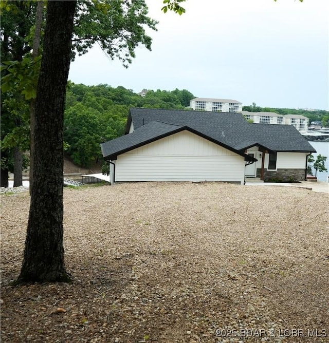 4452 Hamrock Ln, Osage Beach, MO 65065 - view of side of property with roof with shingles