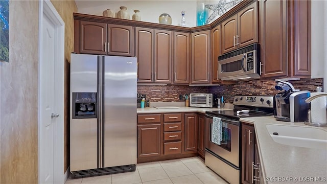 4499 Ski Dr Unit 346, Osage Beach, MO 65065 - kitchen featuring appliances with stainless steel finishes, backsplash, light countertops, and light tile patterned flooring
