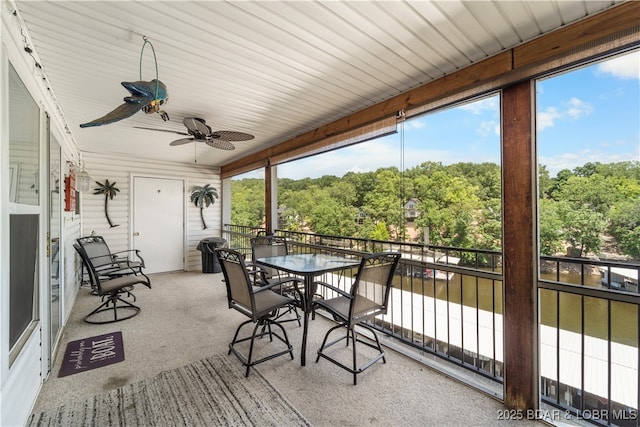 40 Lighthouse Rd Unit 2-301, Lake Ozark, MO 65049 - sunroom with carpet floors, a ceiling fan, and outdoor dining area
