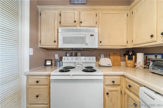 40 Lighthouse Rd Unit 2-301, Lake Ozark, MO 65049 - kitchen featuring white appliances, light countertops, and light brown cabinets