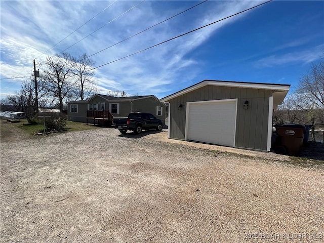 965 Four Waters Dr, Sunrise Beach, MO 65079 - view of front of house featuring a detached garage, an outbuilding, and dirt driveway