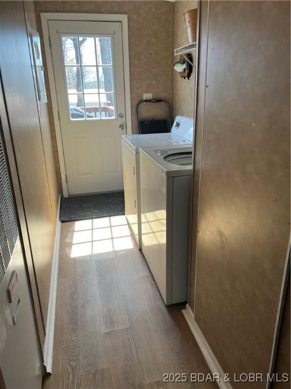 965 Four Waters Dr, Sunrise Beach, MO 65079 - laundry area featuring washing machine and dryer and wood finished floors