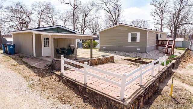 965 Four Waters Dr, Sunrise Beach, MO 65079 - exterior space featuring a patio and a carport