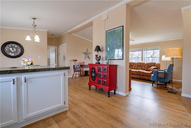 965 Four Waters Dr, Sunrise Beach, MO 65079 - kitchen featuring light wood-style floors, crown molding, white cabinets, pendant lighting, and a chandelier