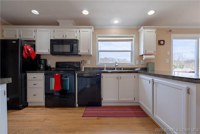 965 Four Waters Dr, Sunrise Beach, MO 65079 - kitchen featuring black appliances, white cabinets, dark countertops, ornamental molding, and a peninsula