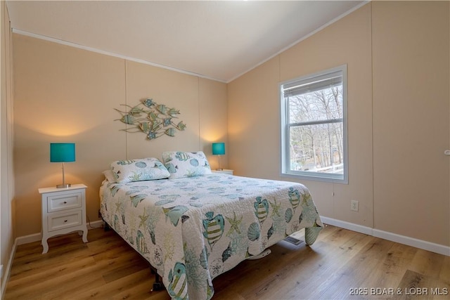 965 Four Waters Dr, Sunrise Beach, MO 65079 - bedroom featuring crown molding, wood finished floors, and vaulted ceiling