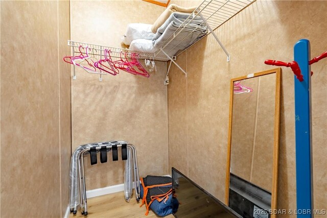 965 Four Waters Dr, Sunrise Beach, MO 65079 - walk in closet with wood finished floors