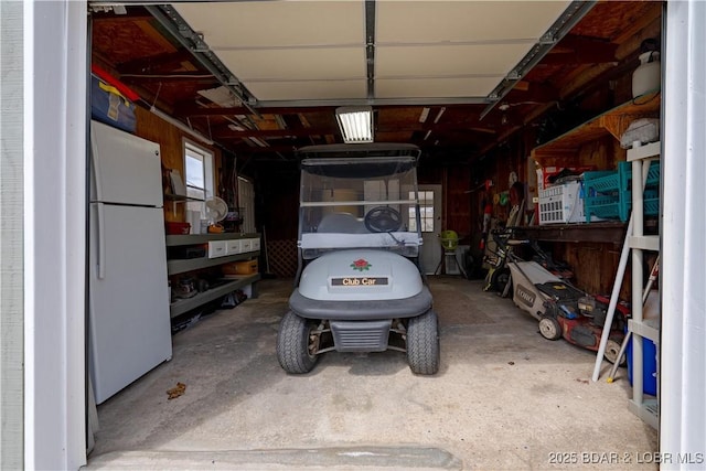 965 Four Waters Dr, Sunrise Beach, MO 65079 - garage with freestanding refrigerator