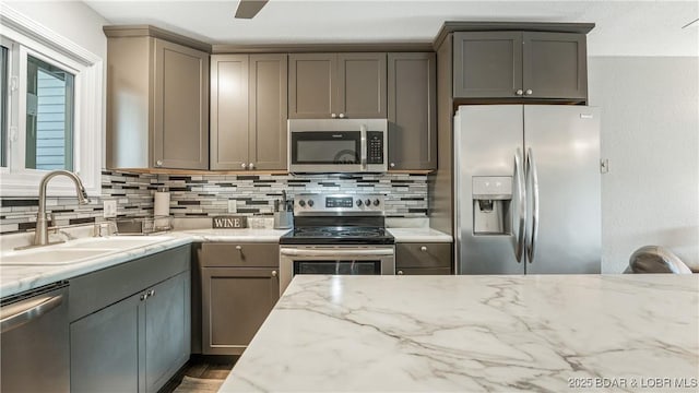 37 Hampton Bay Rd Unit 6, Eldon, MO 65026 - kitchen featuring appliances with stainless steel finishes, backsplash, and gray cabinetry
