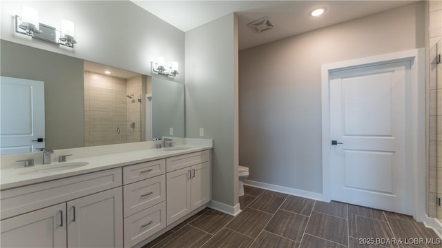 104 Sierra Bay Dr Unit 1A, Camdenton, MO 65020 - full bathroom featuring a stall shower, double vanity, and recessed lighting