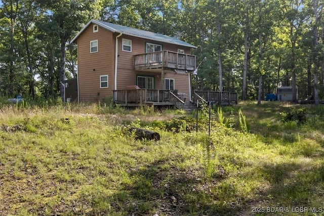 32655 Challenge Dr, Lincoln, MO 65338 - rear view of house with a balcony, a wooden deck, a shed, and a metal roof