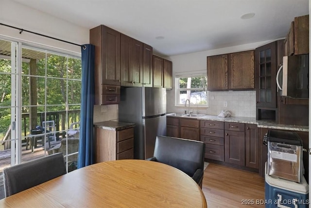 32655 Challenge Dr, Lincoln, MO 65338 - kitchen with appliances with stainless steel finishes, decorative backsplash, and light wood-style floors
