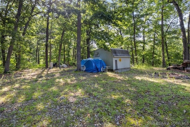 32655 Challenge Dr, Lincoln, MO 65338 - view of yard with a storage unit and a forest view