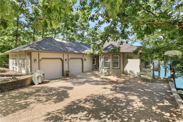 1078 Cornett Branch Rd, Lake Ozark, MO 65049 - ranch-style home with asphalt driveway and an attached garage
