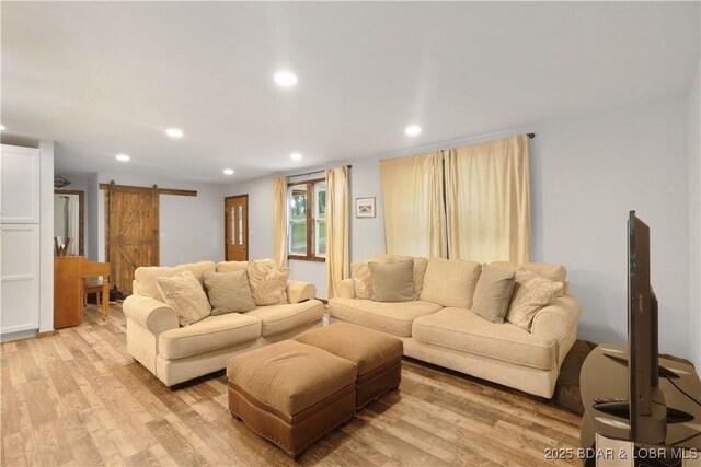 5109 Aqua Dr, Osage Beach, MO 65065 - living room featuring a barn door, light wood-style floors, and recessed lighting