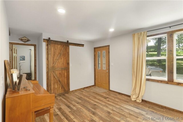 5109 Aqua Dr, Osage Beach, MO 65065 - entryway with a barn door, light wood-style floors, and recessed lighting