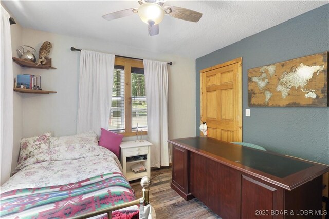 5109 Aqua Dr, Osage Beach, MO 65065 - bedroom featuring wood finished floors, an office area, and a ceiling fan