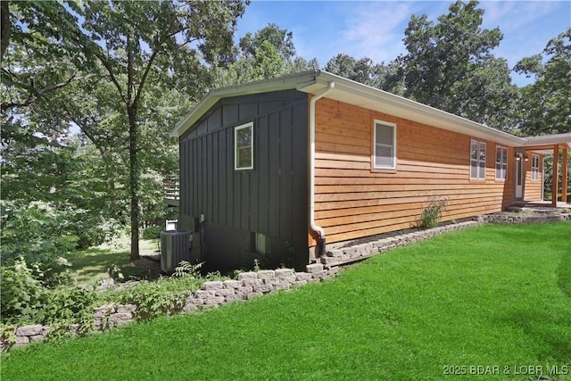 5109 Aqua Dr, Osage Beach, MO 65065 - view of property exterior with board and batten siding and a lawn