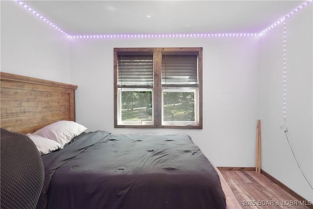 5109 Aqua Dr, Osage Beach, MO 65065 - bedroom featuring wood finished floors and baseboards