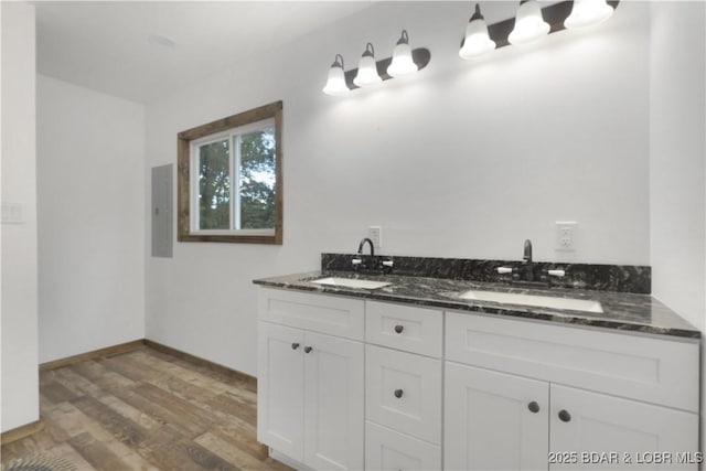 5109 Aqua Dr, Osage Beach, MO 65065 - full bathroom with wood finished floors, double vanity, and electric panel
