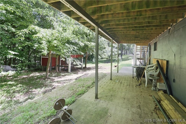 5109 Aqua Dr, Osage Beach, MO 65065 - view of yard featuring a patio area and a storage unit