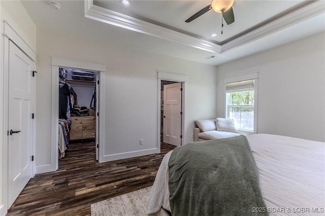 28 Simple Time Dr, Camdenton, MO 65020 - bedroom featuring a raised ceiling, ornamental molding, dark wood-type flooring, a walk in closet, and recessed lighting