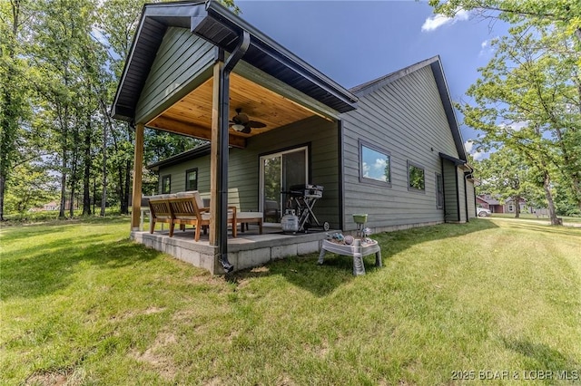 28 Simple Time Dr, Camdenton, MO 65020 - back of house featuring ceiling fan, a patio, and a yard