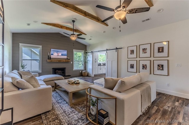 28 Simple Time Dr, Camdenton, MO 65020 - living room with ceiling fan, dark wood finished floors, vaulted ceiling, a barn door, and a fireplace