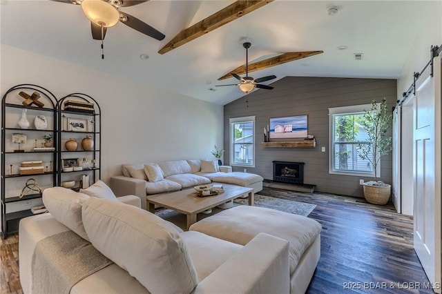 28 Simple Time Dr, Camdenton, MO 65020 - living area featuring a ceiling fan, a barn door, healthy amount of natural light, wood finished floors, and wooden walls