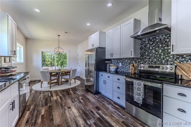 28 Simple Time Dr, Camdenton, MO 65020 - kitchen featuring appliances with stainless steel finishes, wall chimney range hood, tasteful backsplash, dark wood-style floors, and recessed lighting