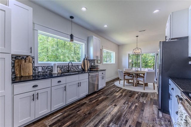 28 Simple Time Dr, Camdenton, MO 65020 - kitchen with dishwasher, dark wood finished floors, white cabinets, backsplash, and pendant lighting